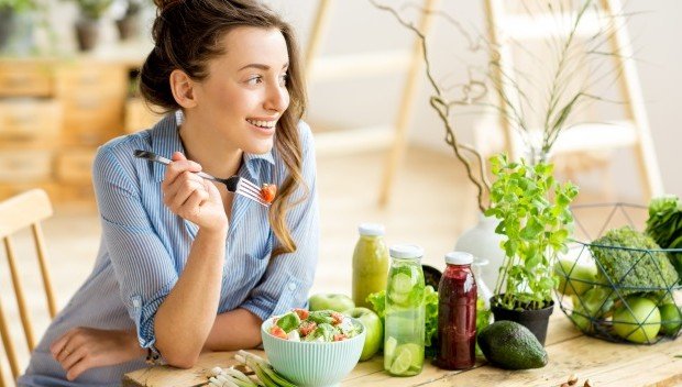 kobieta patrząca na owoce i warzywa