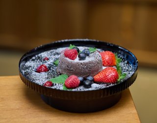 Aksamitny czekoladowy Lava Cake z płynnym środkiem i świeżymi owocami